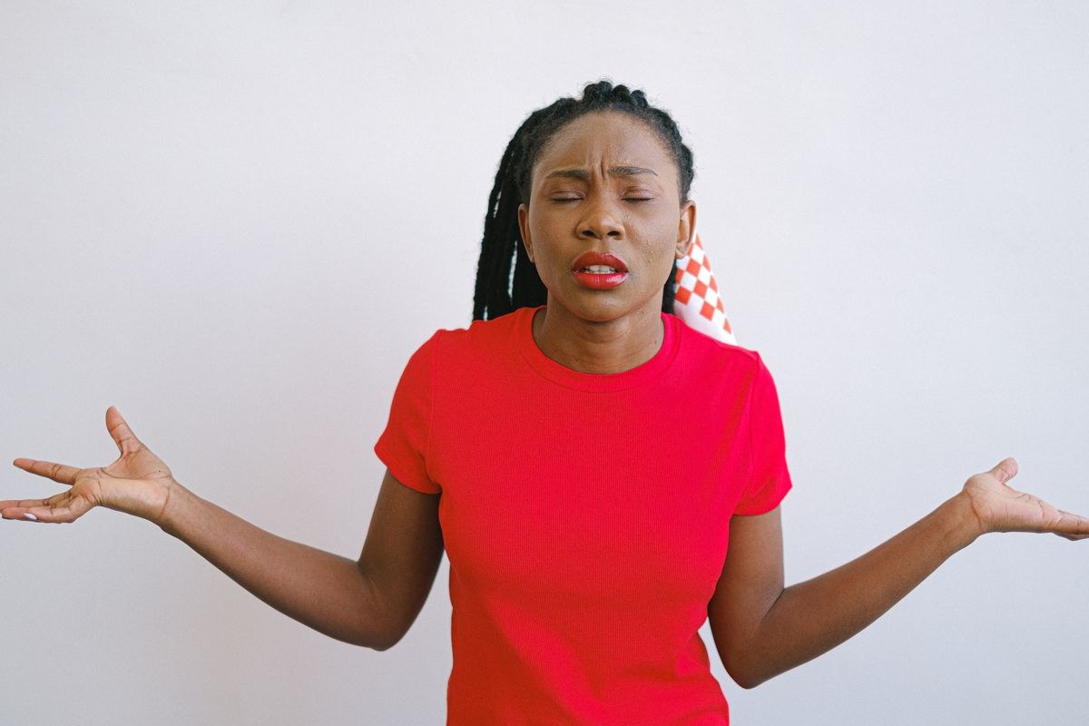 Confused woman shrugging as if asking why would you even ask that