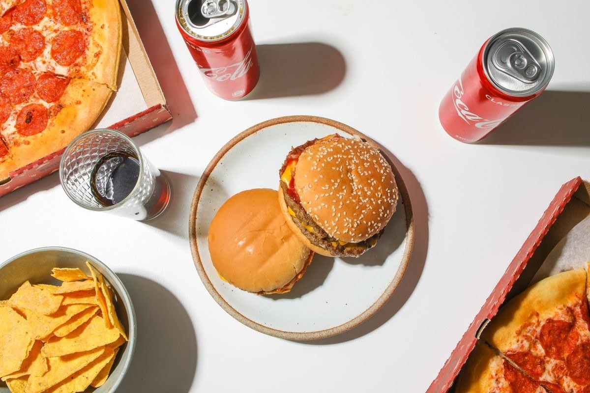 Burger, pizza and fries on a table