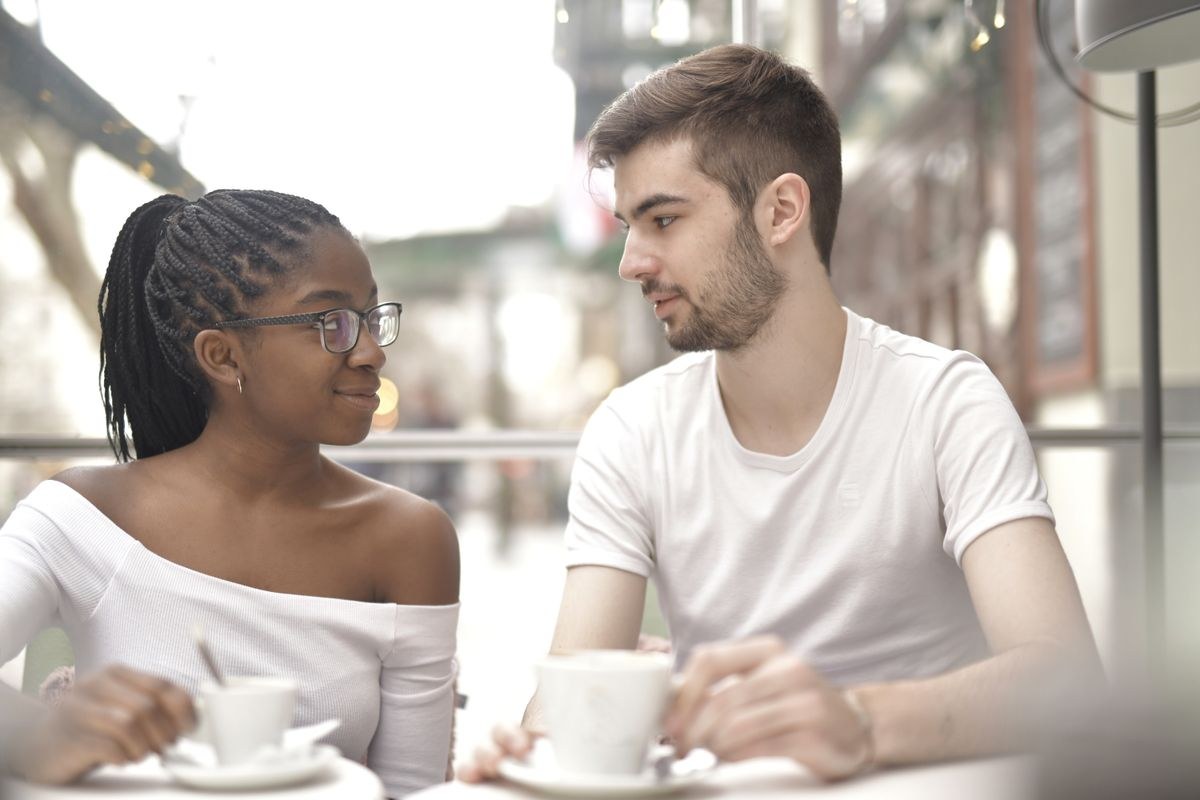 Couple talking over coffee at a cafe